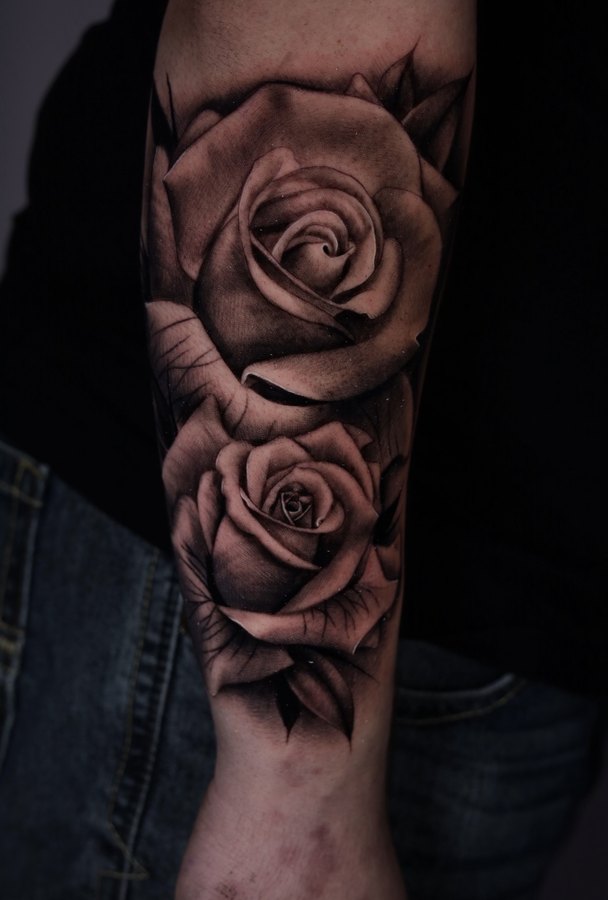 Cartoon characters tattooed along a forearm