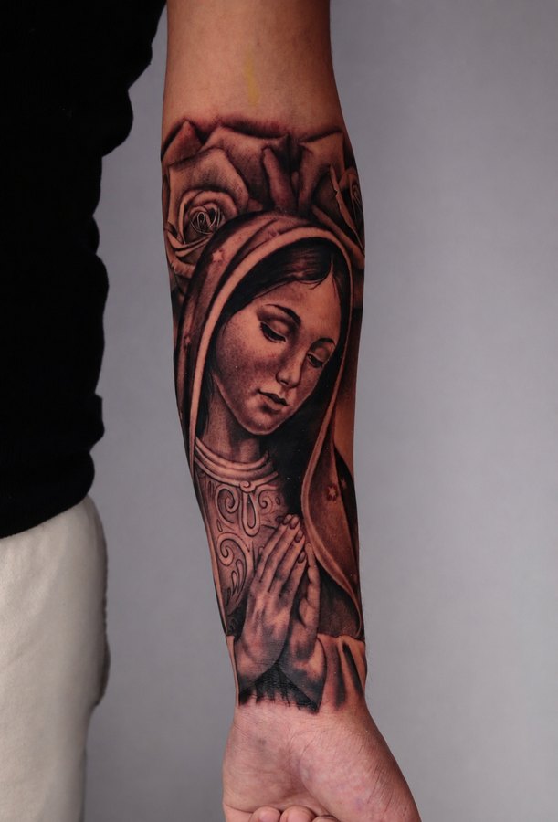 Roaring grizzly bear tattoo in black and grey realism on a forearm