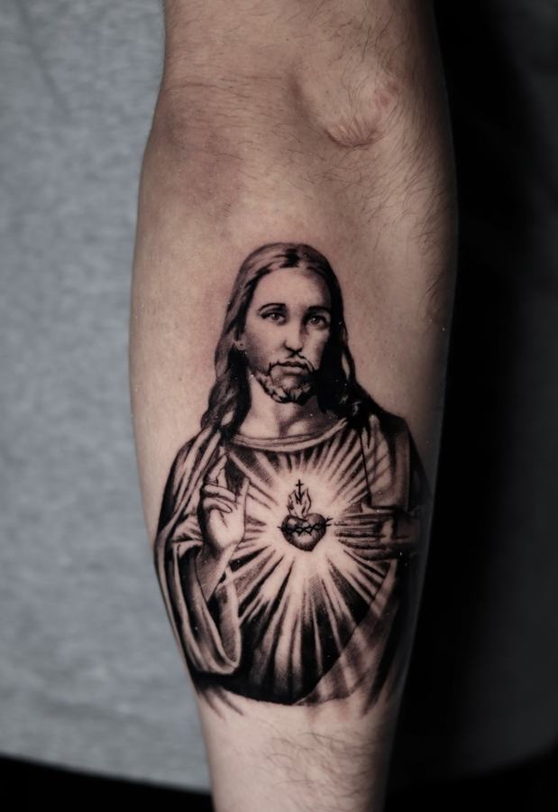 Sacred Heart of Jesus in black and grey realism tattooed on a forearm