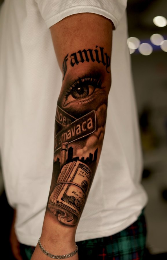Roaring tiger tattoo in black and grey realism running down a leg sleeve